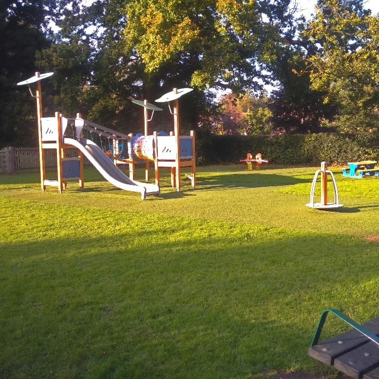 A playground with a safe surface seen from a distance in the rays of the setting sun